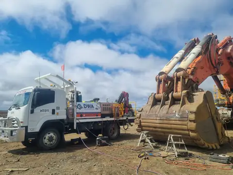 DWA crane truck beside an excavator bucket
