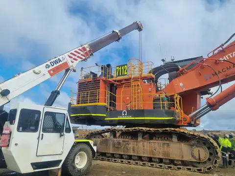 DWA crane working on a large excavator