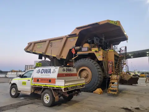 DWA service ute beside a mining haul truck