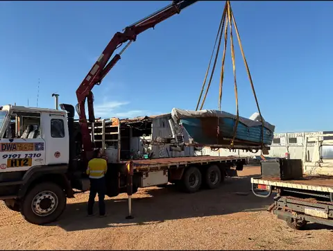 Hiab truck lifting an aluminium boat